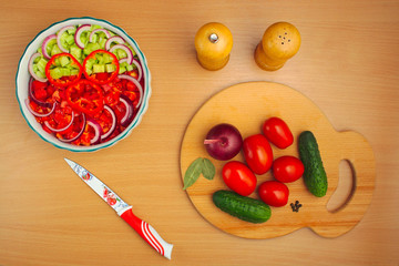 salad of cucumber and tomato cooking, salt and pepper