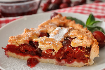 Delicious piece of cherry pie on white plate