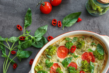 Baking dish with broccoli casserole on table