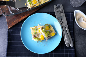 Plate with tasty broccoli casserole on table