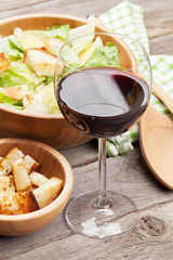 Red wine glass and caesar salad