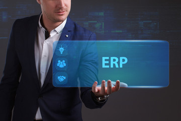 Business, Technology, Internet and network concept. Young businessman working on a virtual screen of the future and sees the inscription: ERP