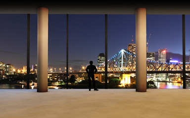 Rear view at young successful businessman standing in the office