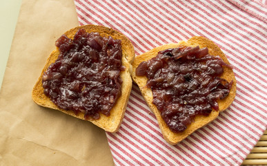 Canape with caramelized red onion marmalade, crispy toast top view.