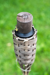 Close-up of traditional bamboo torches oil lamp on nature background.