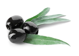 Black olives with leaves, isolated on white