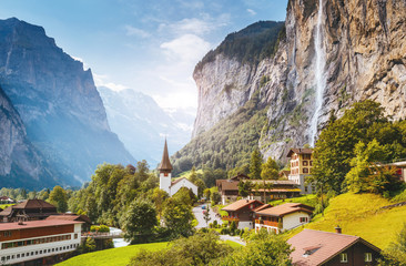 Naklejka premium Majestic view of alpine village. Swiss alps, Lauterbrunnen valley, Staubbach waterfall, Europe.