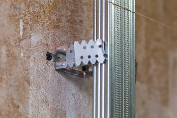 Interior of apartment with materials during on the construction, remodeling, rebuilding and renovation ( making metall frames on the wall for drywall)