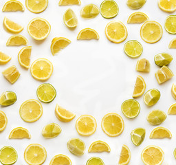 Frame with lemon and lime slices isolated on white background view from above