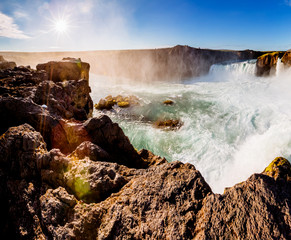Nice views of the bright sunlit powerful Godafoss cascade. Location Skjalfandafljot river, Iceland, Europe. Beauty world.