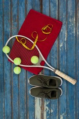 Overhead view of tennis equipment and tape measure on napkin by