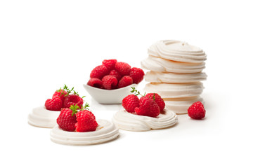 Mini  Pavlova meringue nests with raspberries and thyme on isolated on white