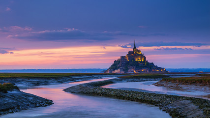 Panoramic view of famous Le Mont Saint-Michel tidal island at sunset, Normandy, northern France - obrazy, fototapety, plakaty