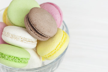 Different macaroons in a vase on the table