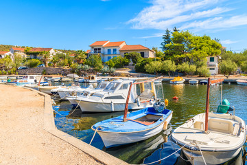 Fototapeta na wymiar Fishing boats mooring in small bay near Primosten town, Dalmatia, Croatia