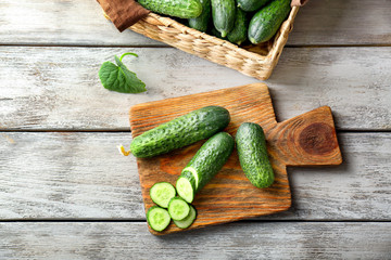 Green fresh cucumbers on wooden board
