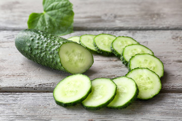 Fresh sliced cucumber on wooden table
