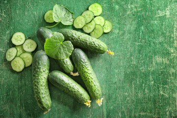 Green fresh cucumbers on wooden table