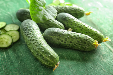 Green fresh cucumbers on wooden table