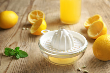 Lemon squeezer on wooden background