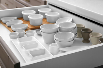 Set of tableware in kitchen drawer
