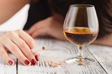 Drunk woman in lace underwear with glass of whiskey