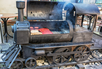 Barbecue grill with meat in shape of old steam locomotive