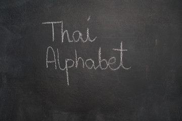 "Thai Alphabet" written with white chalk on blackboard