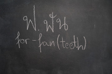Fototapeta premium Thai letter written with white chalk on blackboard