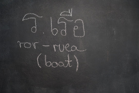 Thai letter written with white chalk on blackboard