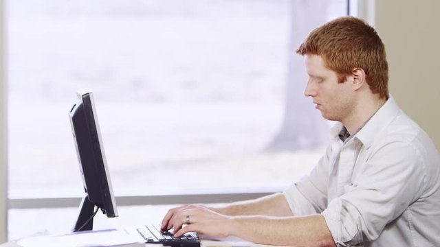 Business man typing on computer