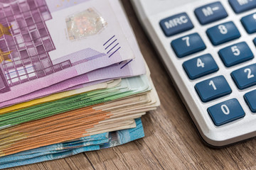 euro bills with calculator, close up