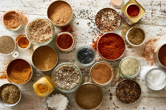 Many different spices and seasoning on wooden table