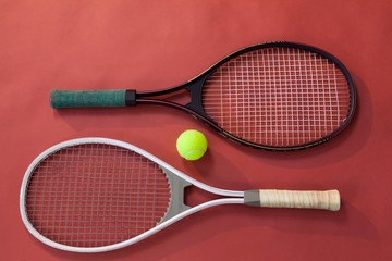 High angle view of ball amidst tennis rackets