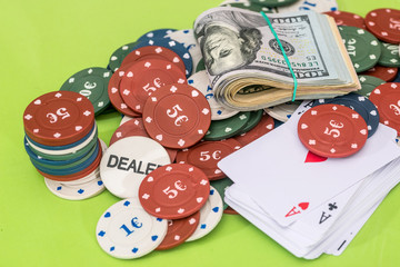 poker combination - chips, card, dollar isolated on green