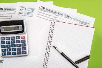 tax form, pen, note and calculator