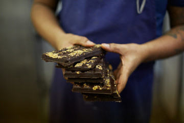 Close up of hands holding chocolate tablets
