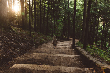 Child hiking though woods