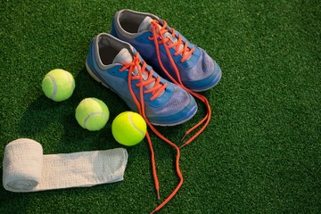 Sports shoes with tennis ball and napkin - Powered by Adobe