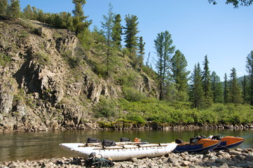 Two inflatable catamarans on the shore of a mountain river. Chaya river, North Baikal Highlands, ...