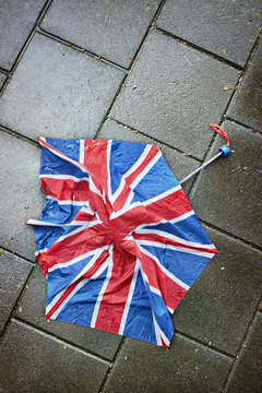 A broken umbrella  on the pavement