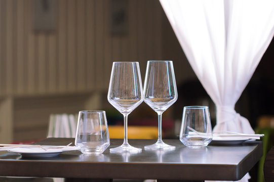 Close up picture of empty glasses set on the table in restaurant background.