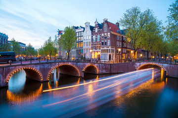 Obraz premium Amsterdam Canal and Light Trails of a Vessel
