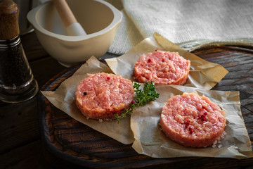 raw the chicken Patty for the Burger on the table kitchen