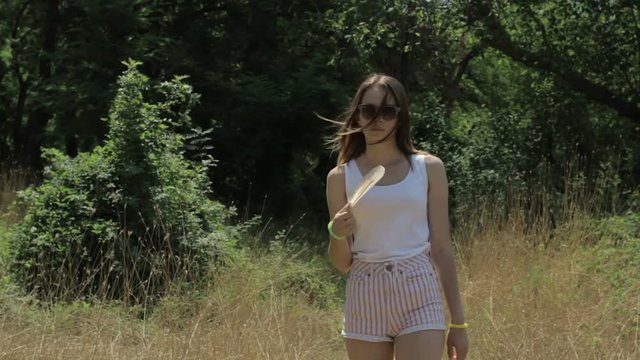 Young cute girl with fan, outdoor, slow motion  