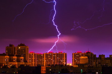 Lightning strikes the building. Thunderstorm over buildings.