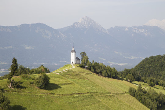 Jamnik church with Mount Triglav on the background. Jamnik, Kranj municipality, Upper Carniola Region, Slovenia.