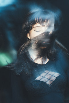 Woman fashion model wearing all black at night long exposed with flash