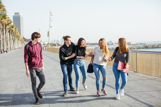 Group of teen students walking on the street after school.