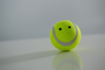 Close up of tennis ball with anthropomorphic face